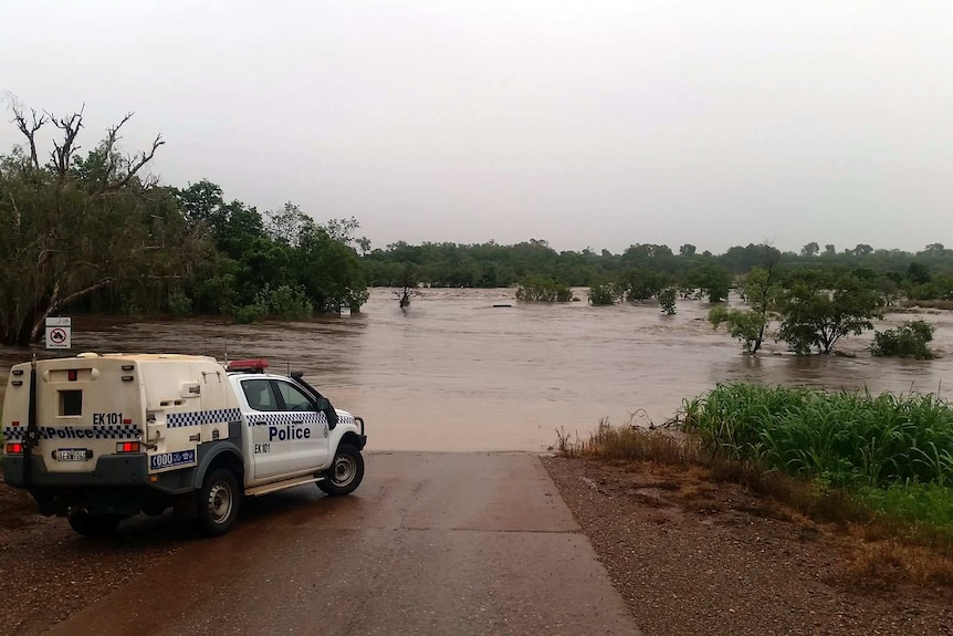 A police car near the edge of the flooded Ord River.