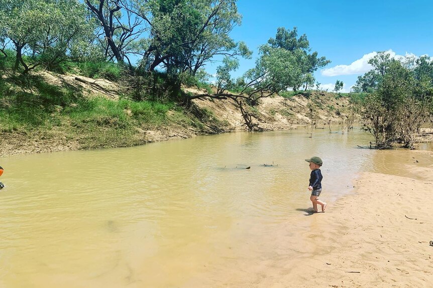 A child swims in river. 