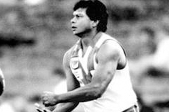 Northern Territory-born football star Maurice Rioli handballs during a game.