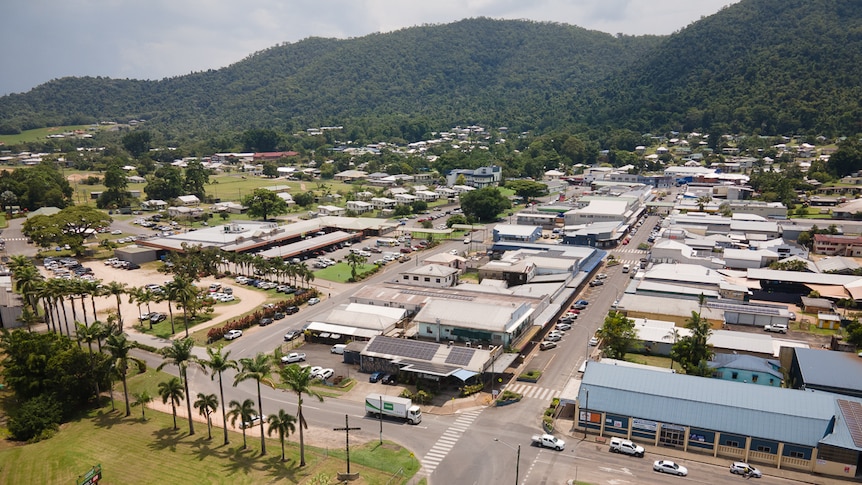 An aerial view of a small town with hills in background.