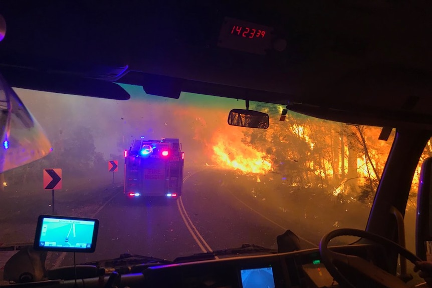 Firefighters battle a blaze beside the highway near Toowoomba