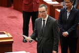 Independent South Australian Senator Tim Storer is being sworn in. Penny Wong is in the background.