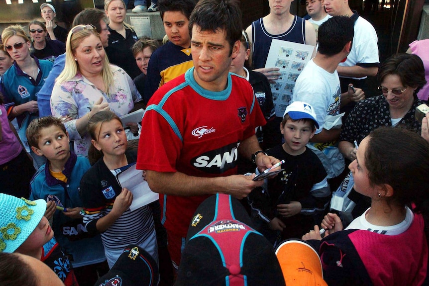 Ryan Girdler is surrounded by fans at Penrith Panthers training before the 2003 NRL grand final.