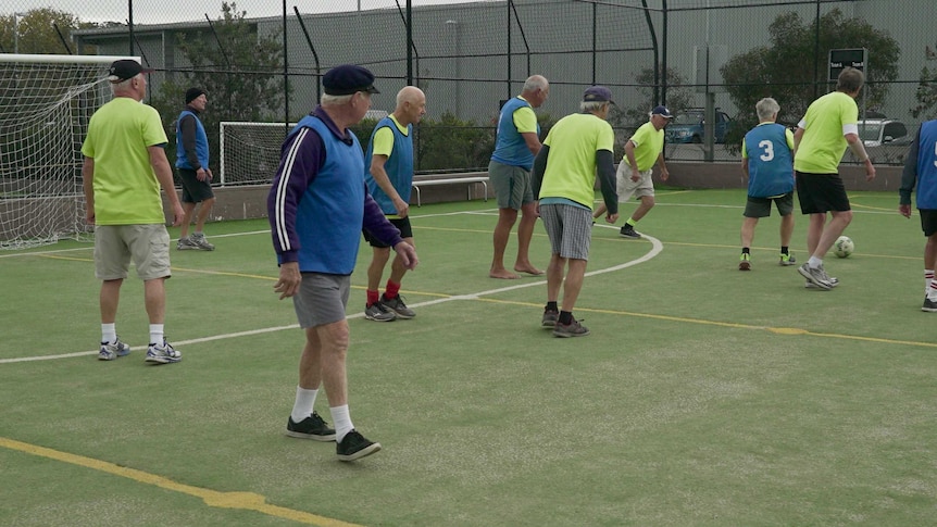 Group of men play a walking football game.