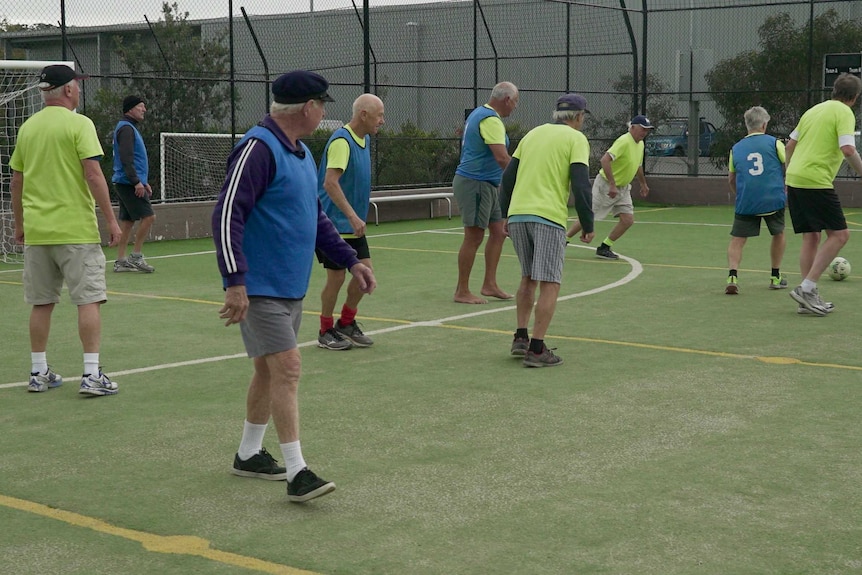 Group of men play a walking football game.