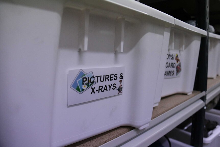 Plastic bin with 'pictures and x-rays' written on it