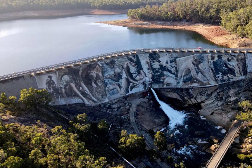 A very large mural of children playing on the side of the Wellington Dam in Collie