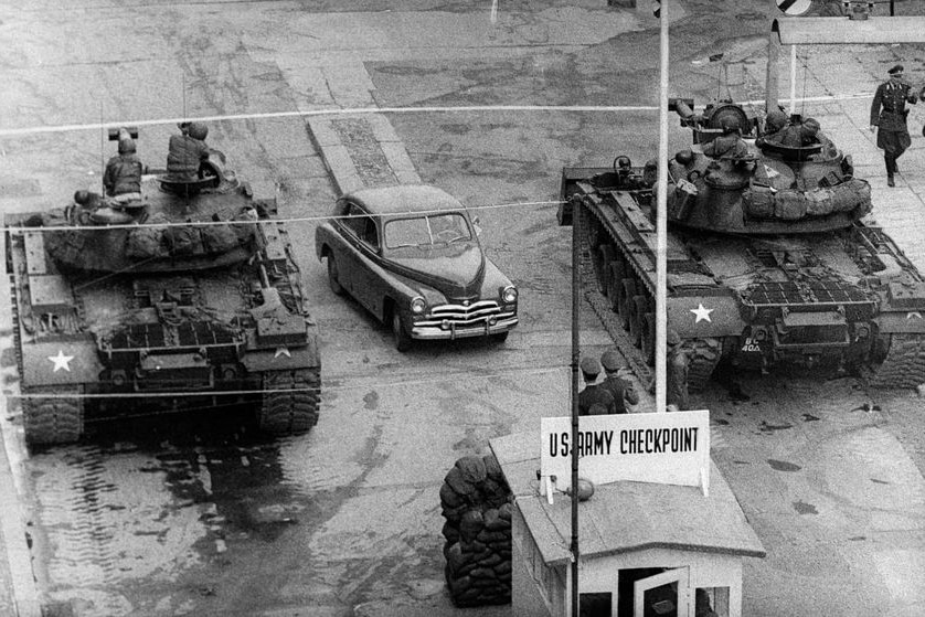 A car rides between United States tanks, in October 1961