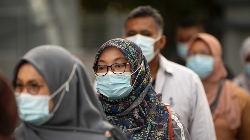 Residents line up for coronavirus testing on the outskirts of Kuala Lumpur