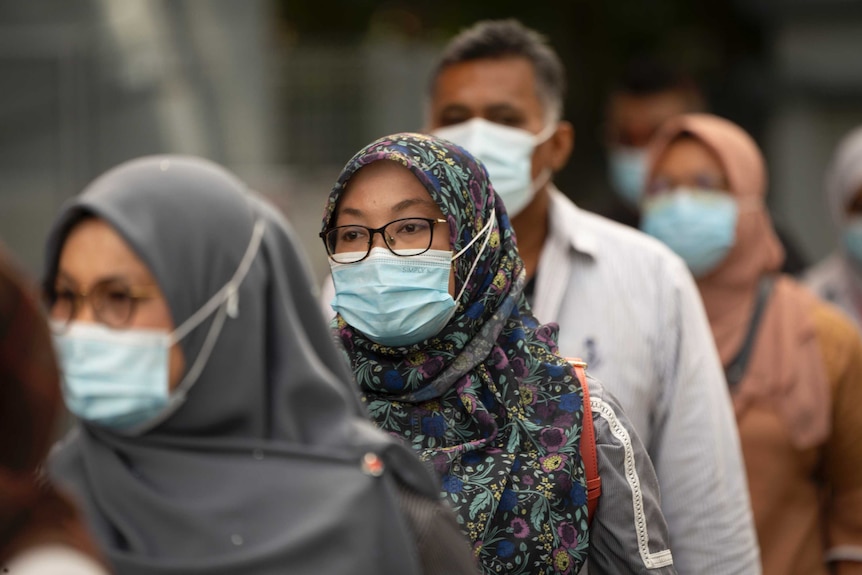 Residents line up for coronavirus testing on the outskirts of Kuala Lumpur