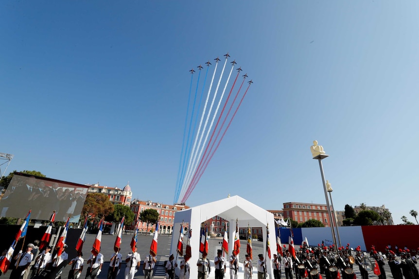 Alpha jets of the Patrouille de France fly over Nice, leaving trails of blue, white and red.