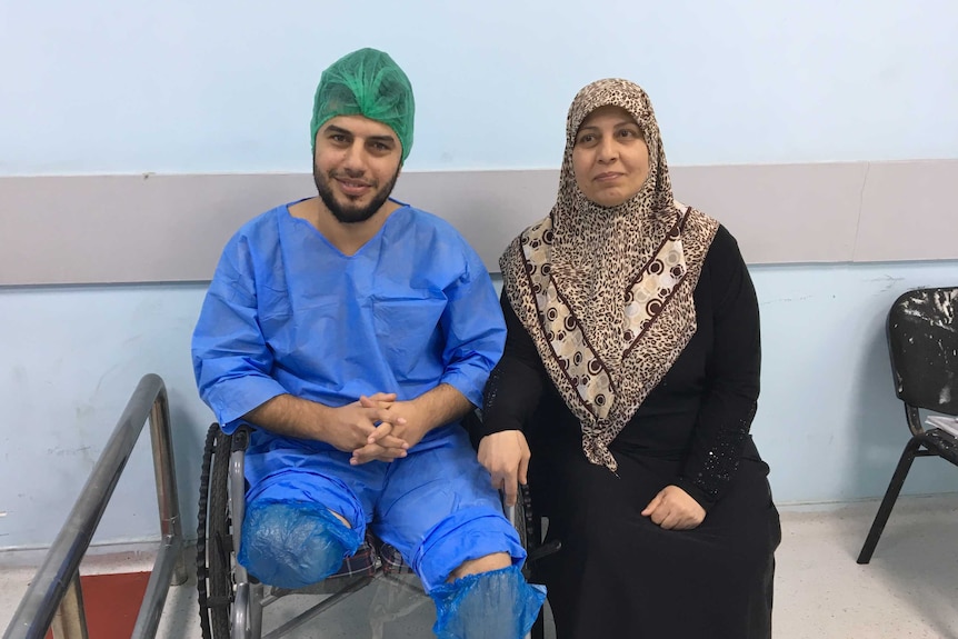 Ghadban sits next to his mother Amira.