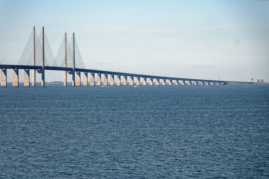 A bridge stretches across a large expanse of water.