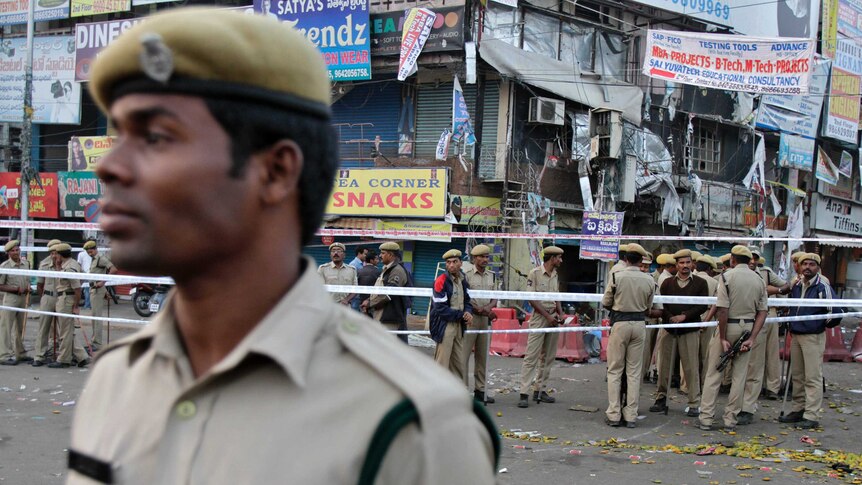 Policemen stand guard at the site of an explosion at Dilsukh Nagar in the southern Indian city of Hyderabad.