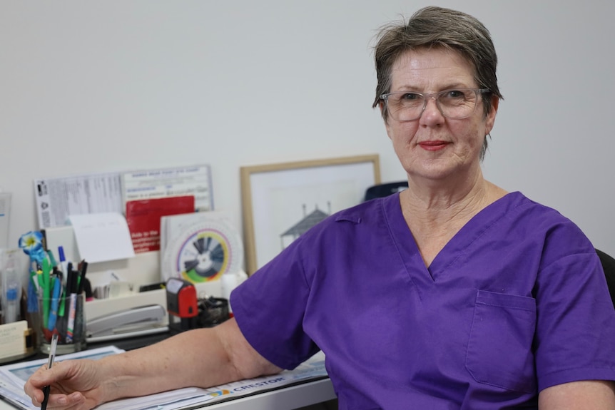 Dr Marion Magee sitting at a desk