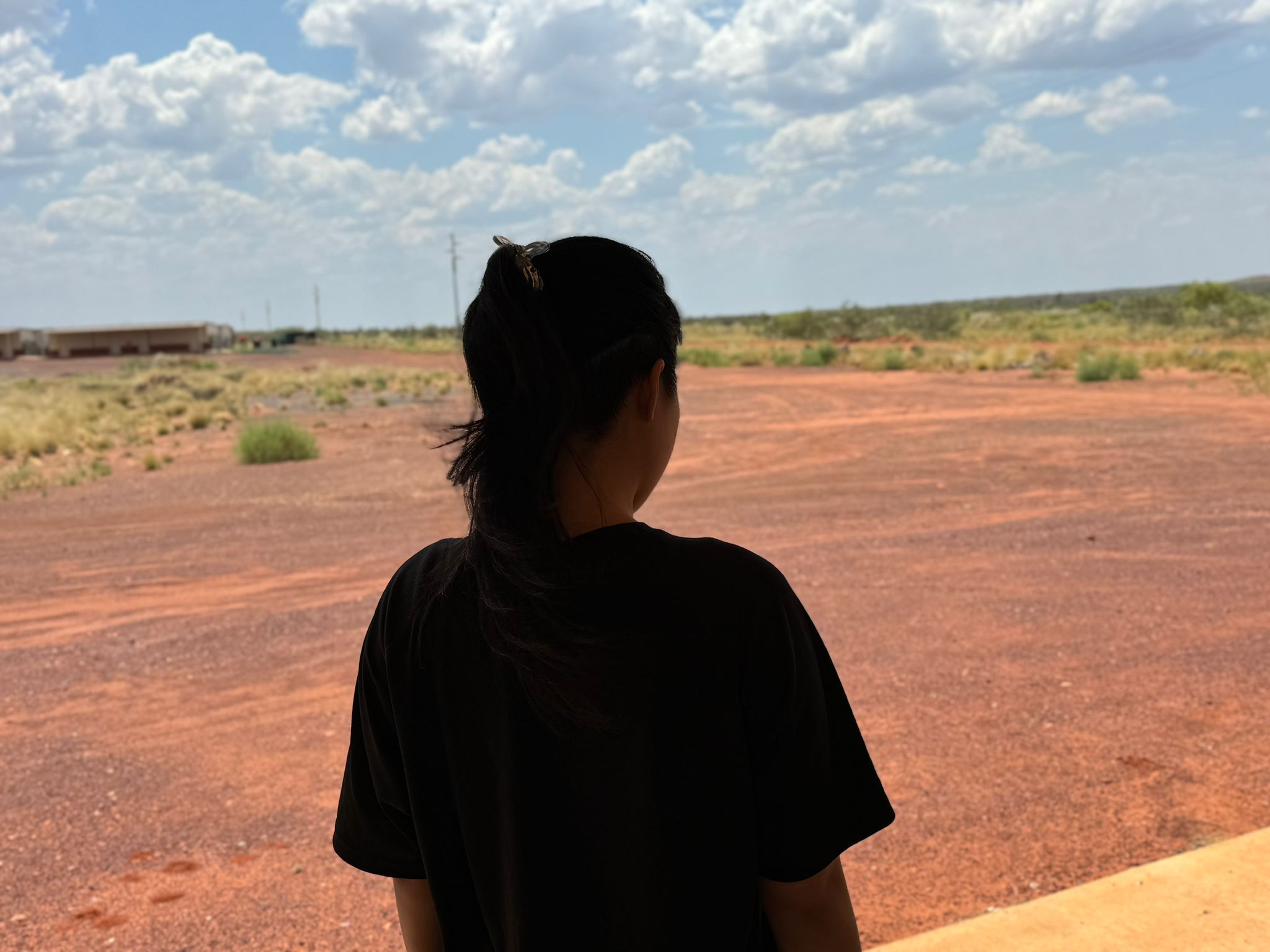 Woman in ponytail pictured from behind.