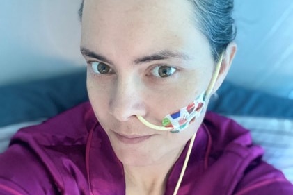 a woman takes a selfie with a nasogastric tube on her face