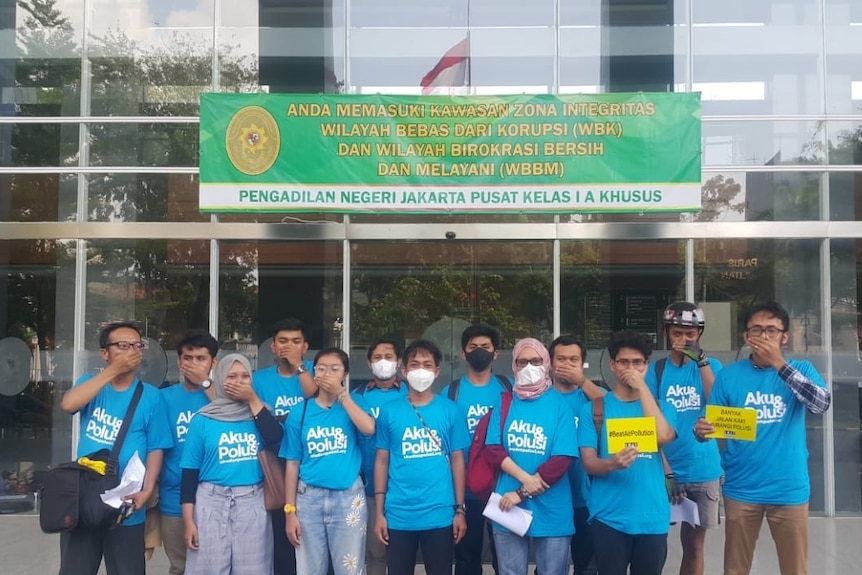 A group of people closing their noses and mouths demanding for better air quality