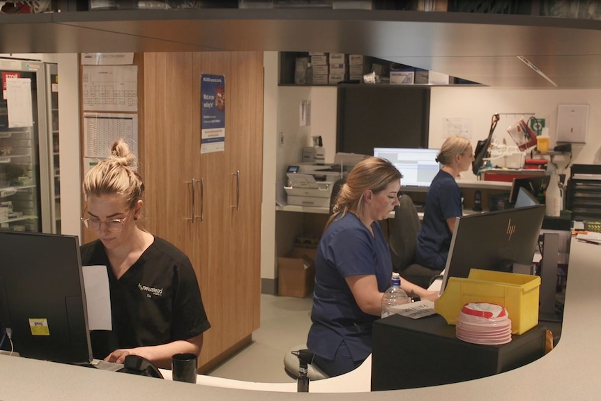 Staff at reception of medical centre.