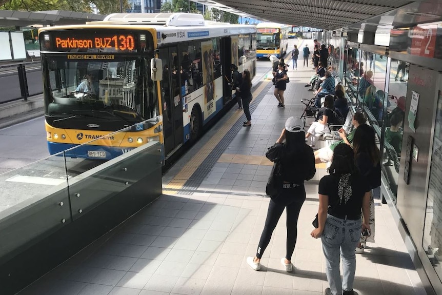 generic of bus station with waiting passengers at the South Bank Cultural Centre