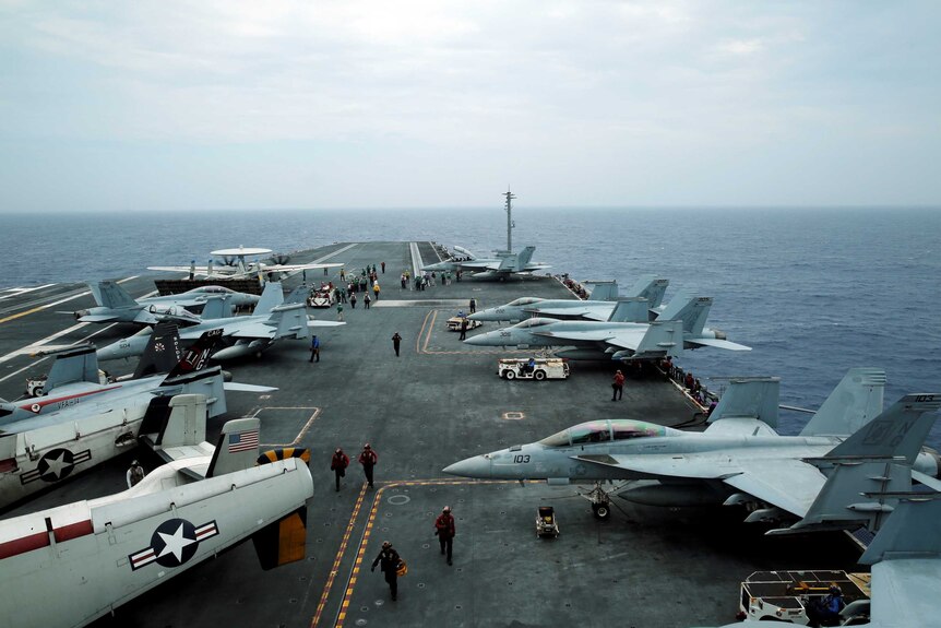 Exercise Malabar off the coast of Okinawa, Japan, with planes seen on an US aircraft carrier.