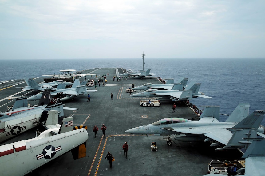 Exercise Malabar off the coast of Okinawa, Japan, with planes seen on an US aircraft carrier.