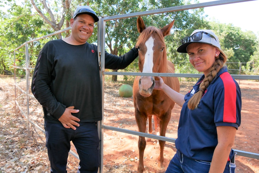 Tia and Boyo Petrevski stand with a horse in Broome.