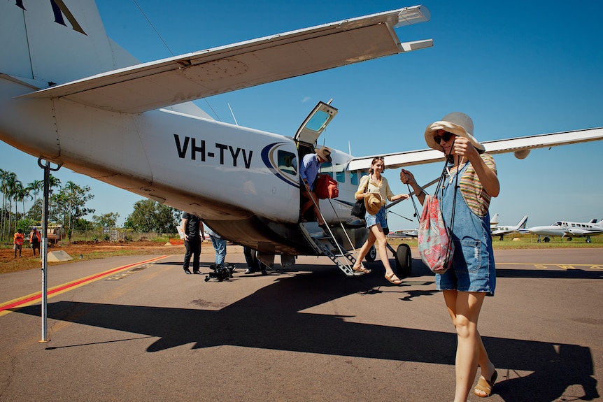 tourists getting out of a mini plane