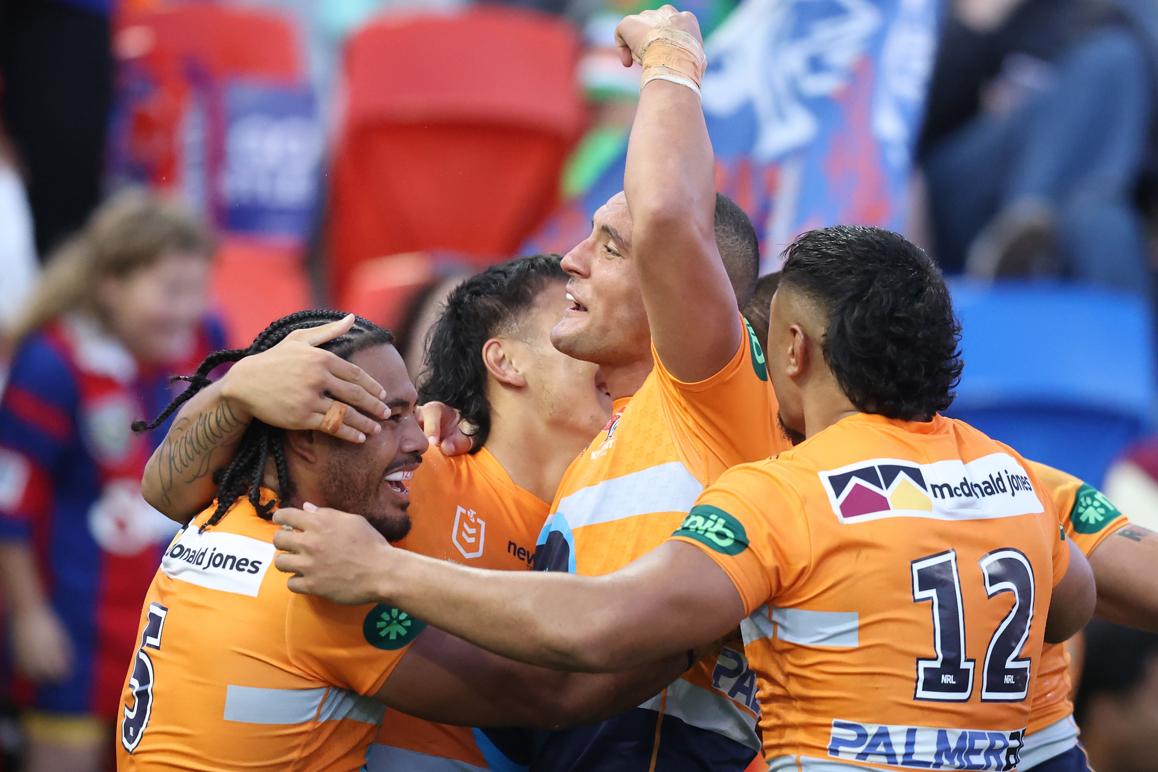 A group of rugby league players celebrate a try
