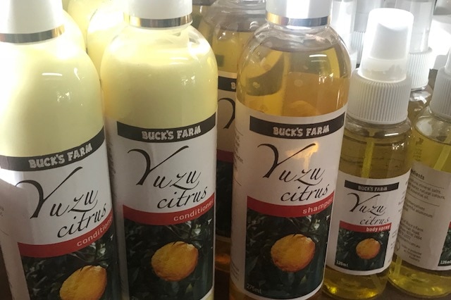 Various bottles of yuzu products such as conditioner, shampoo and body spray.