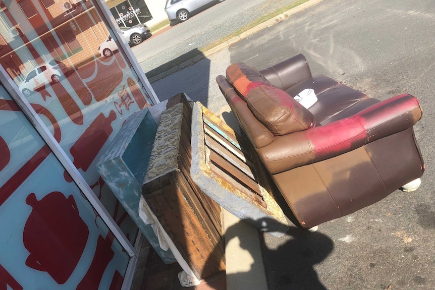 Unwanted furniture sits in op shop car park