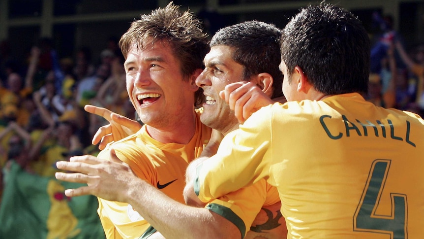 Harry Kewell and Tim Cahill celebrate with John Aloisi