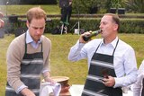 Britain's Prince William and New Zealand's Prime Minister John Key cook up a few beef fillet steaks