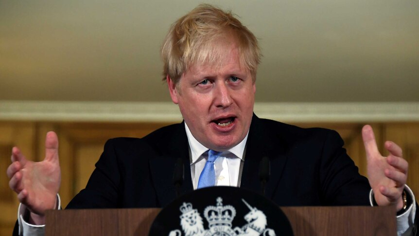 Boris Johnson gestures with his hands
