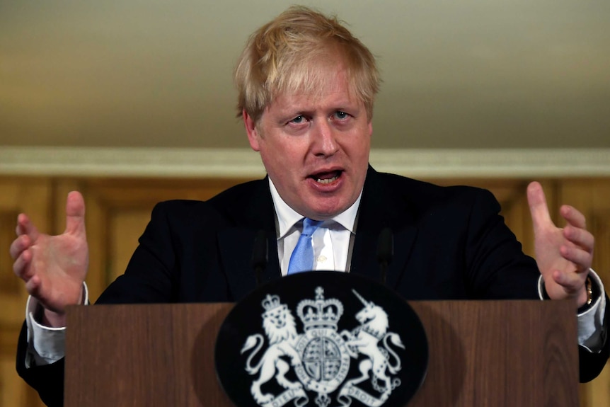 Boris Johnson gestures with his hands