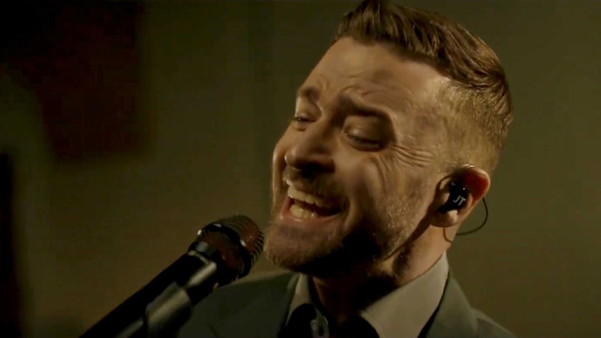 Justin Timberlake sings into a microphone