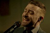 Justin Timberlake sings into a microphone