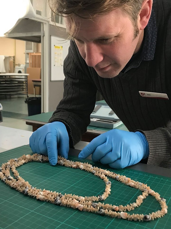 QVMAG history curator Jon Addison lays out an Aboriginal shell necklace in preparation for purpose-built mounts to be constructed for The First Tasmanians: Our Story exhibition