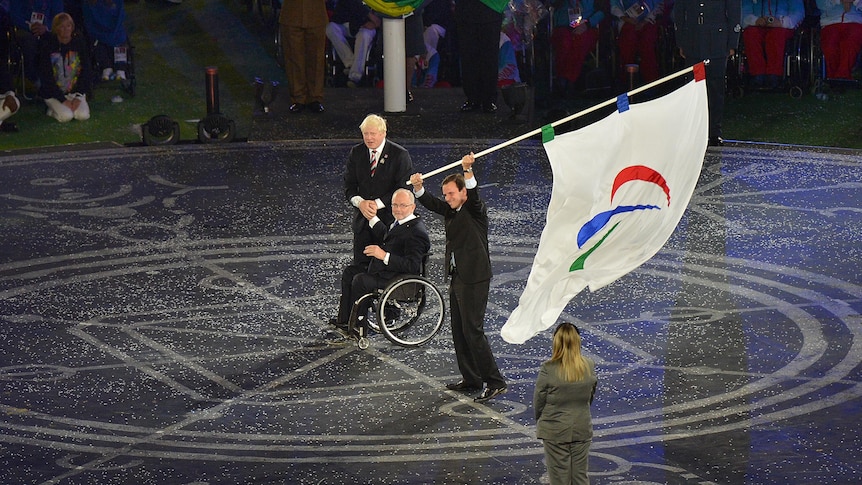 Mayor of Rio de Janeiro Eduardo Paes waves the Paralympic flag during the handover ceremony