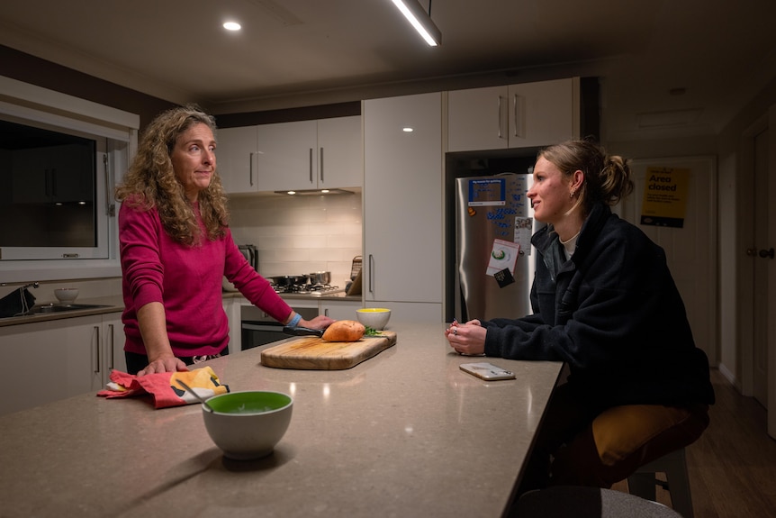 Mother Nikola and her daughter Ruby talk in the kitchen