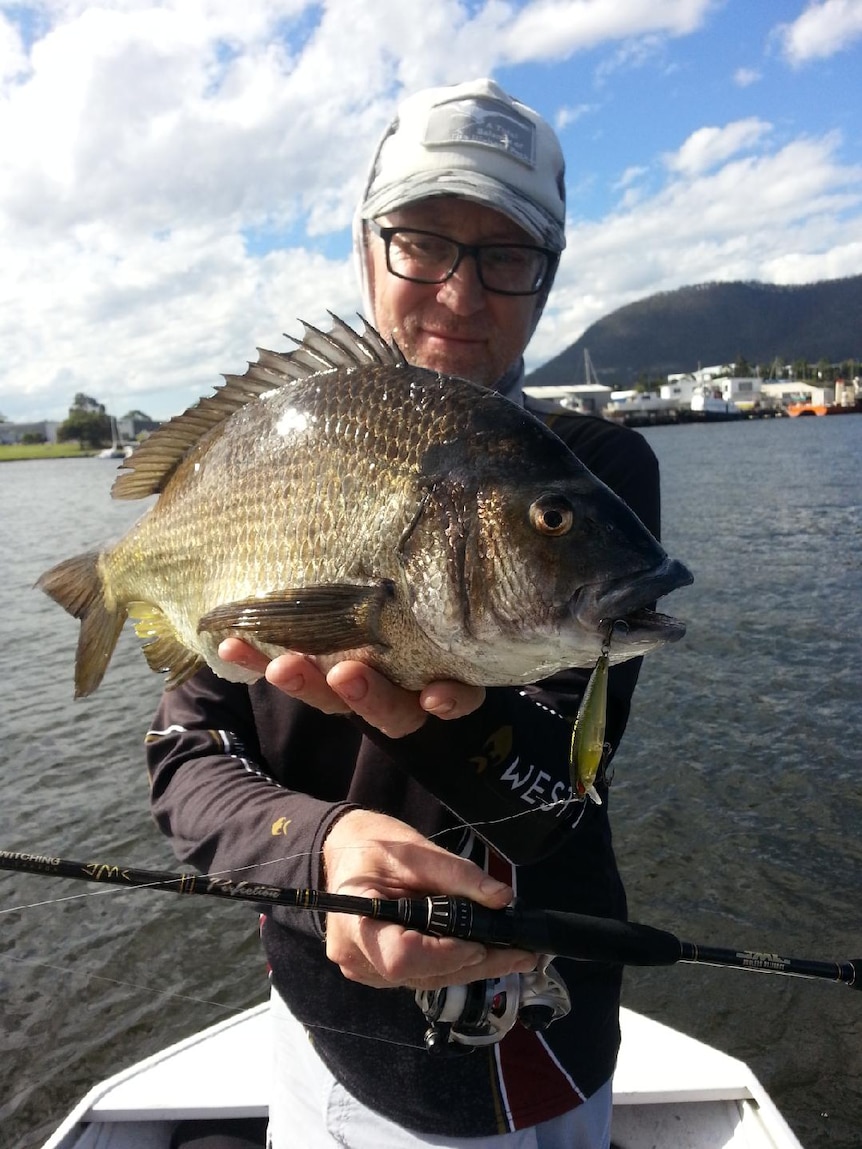 Plinio Taurian holds a bream