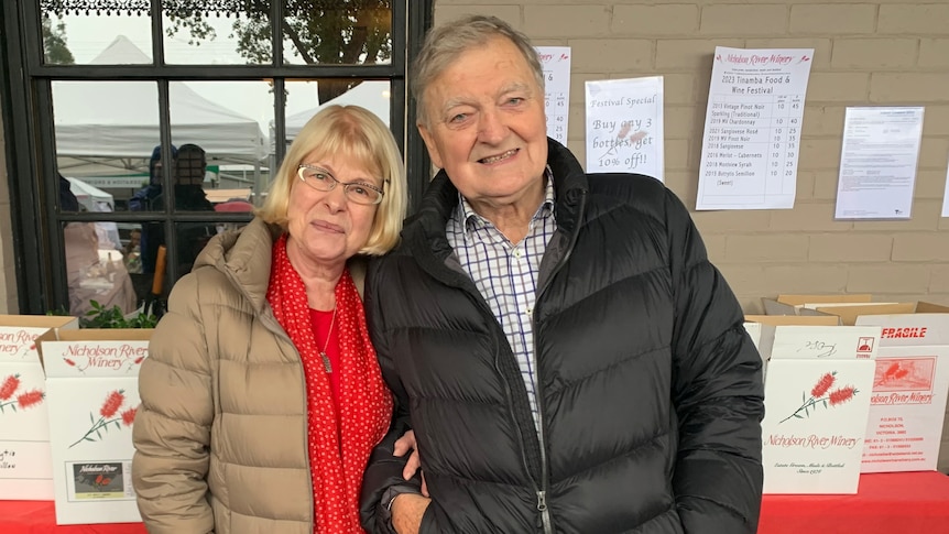 a woman and a man wearing puffer jackets.