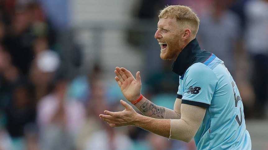 Ben Stokes smiles and claps his hands together