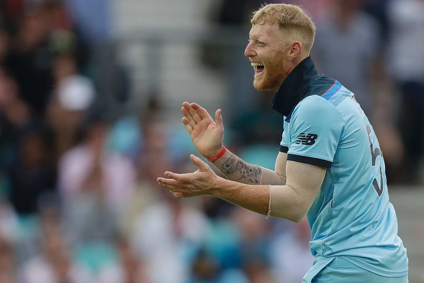 Ben Stokes smiles and claps his hands together