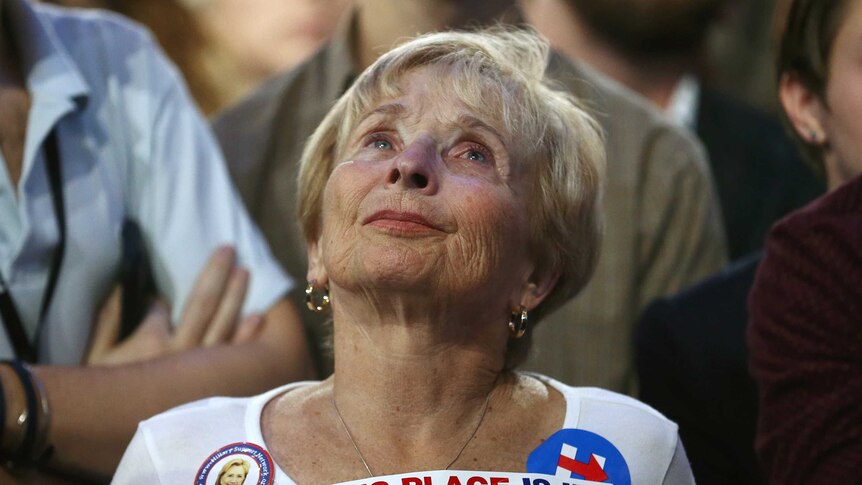 A Clinton supporter watches and waits for election results