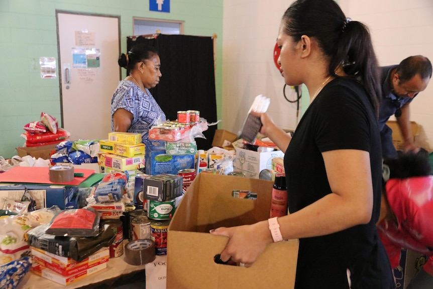 People pack donations to Timor-Leste after floods and landslides, Darwin, April 2021.