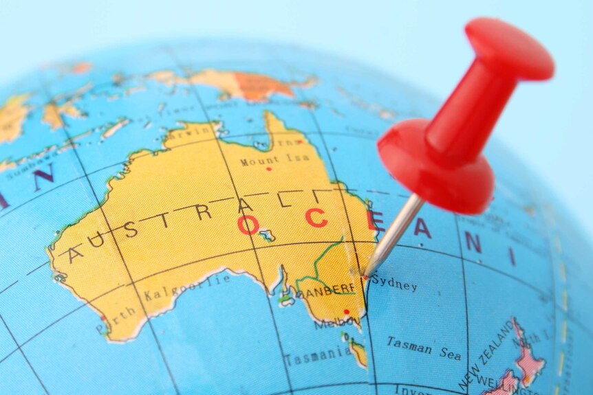 Pushpin points out Sydney in plastic globe.