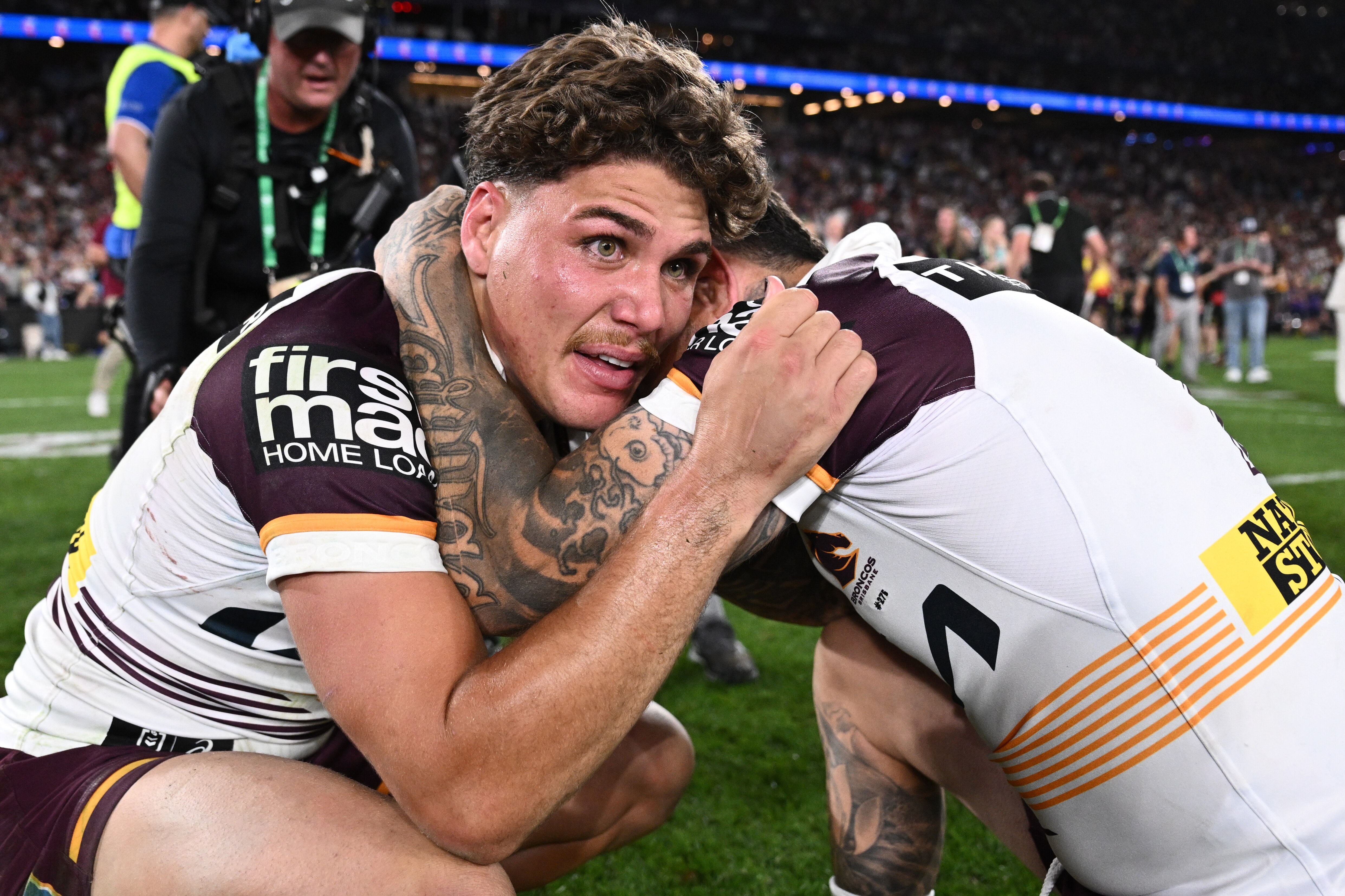 Reece Walsh hugs Adam Reynolds after the NRL grand final.