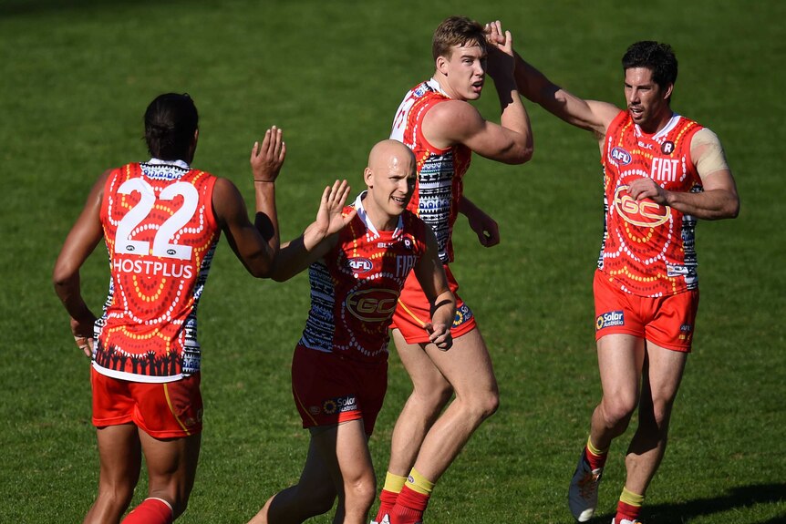 Gary Ablett (C) reacts after a goal for Gold Coast against St Kilda at Carrara on July 2, 2016.