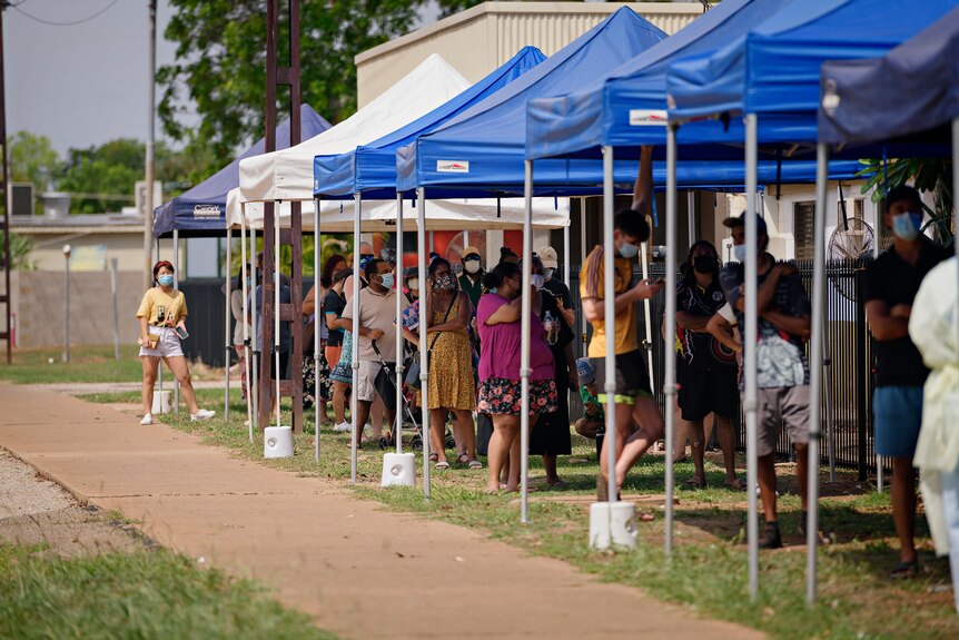 A long line of people queuing up for COVID testing in Katherine.